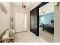 Inviting foyer featuring a sliding barn door, natural light, decorative accents and welcoming decor at 6477 Dutton Dr, Wesley Chapel, FL 33545