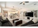 Open living room with tile flooring, recessed lighting, and an adjacent kitchen area at 6477 Dutton Dr, Wesley Chapel, FL 33545