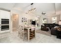 Open-concept kitchen, dining, and living area with plenty of natural light at 6477 Dutton Dr, Wesley Chapel, FL 33545