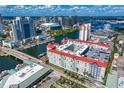 An aerial view of a waterfront condo complex in an urban setting, featuring a red tile roof, ample parking, and nearby downtown amenities at 700 S Harbour Island Blvd # 547, Tampa, FL 33602