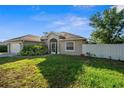 Inviting single-story home with lush front lawn, screened entrance and attached two-car garage at 7288 Castleberry Ter, Englewood, FL 34224