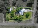 A lovely home with pool and detached garage surrounded by mature trees on a large private lot at 7508 W Short Rd, Plant City, FL 33565