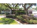 Home featuring mature landscaping, a stone facade, and a brick driveway at 8238 30Th N Ave, St Petersburg, FL 33710