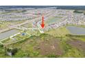 Expansive aerial shot of the property showing its location in a community with water features and green spaces at 8598 Parsons Hill Blvd, Wesley Chapel, FL 33545