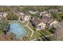 Aerial view of condo community highlighting tennis court, landscaped grounds, and building exteriors at 8724 Mallard Reserve Dr # 101, Tampa, FL 33614