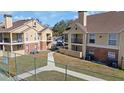 Scenic view of condominium complex with tennis court, lush landscaping, and building exteriors at 8724 Mallard Reserve Dr # 101, Tampa, FL 33614