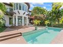 Gorgeous outdoor pool area with patio, jacuzzi and lush tropical landscaping at 90 Bahama Cir, Tampa, FL 33606