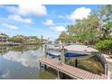 Boat on lift at private dock with water views and easy access to waterway at 90 Bahama Cir, Tampa, FL 33606