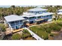Aerial view of home showcasing expansive decks, screened porches and waterfront access at 9048 Wharf Ave, Placida, FL 33946