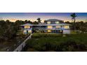 Exterior of waterfront home with multiple levels, decks and balconies offers stunning sunset views at 9048 Wharf Ave, Placida, FL 33946