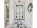Inviting foyer with decorative front door, a stylish mirror, and contemporary flooring at 11146 Rustic Timber Loop, San Antonio, FL 33576