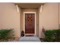 Close-up of the front door adorned with a festive wreath and stylish accents at 11704 Castine St, New Port Richey, FL 34654