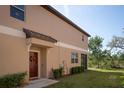 Inviting front entrance with a decorative wreath on the dark brown door at 11704 Castine St, New Port Richey, FL 34654