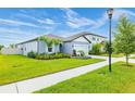 A beautiful home with landscaped grounds showing its architectural details and curb appeal under a sunny sky at 12916 Brookside Moss Dr, Riverview, FL 33579