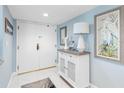 Light-blue hallway with artwork, console table, lamp, and decorative pieces at 1460 Gulf Blvd # 509, Clearwater Beach, FL 33767