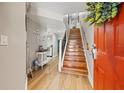 Welcoming foyer with hardwood floors, staircase, and stylish decor at 14910 Par Club Cir, Tampa, FL 33618