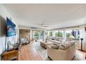 Bright and airy living room with sliding glass doors to the outdoors at 1500 Sunset Rd # F8, Tarpon Springs, FL 34689