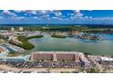 Scenic aerial view capturing the building, marina, and the surrounding residential area by the water at 1847 Shore S Dr # 204, South Pasadena, FL 33707