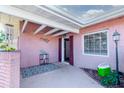 Inviting front porch with brick accents, decorative shutters, and a stylish welcome mat at 2030 Magnolia Dr, Clearwater, FL 33764