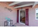 Charming front porch with red shutters, decorative wall hangings, and a welcoming entryway at 2030 Magnolia Dr, Clearwater, FL 33764