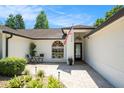 Inviting front entrance with a beautiful paver walkway and stylish seating area at 2347 Foggy Ridge Pkwy, Land O Lakes, FL 34639