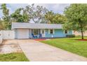 Charming home featuring a well-manicured lawn and driveway leading to the attached garage at 2616 Fairway S Ave, St Petersburg, FL 33712