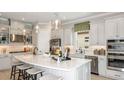 Modern kitchen featuring a large center island, stainless steel appliances, and stylish pendant lighting at 29936 Rusco Ct, Wesley Chapel, FL 33543