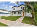 Charming two-story home with green grass, walkway and tidy landscaping on a sunny day at 3455 17Th S Ave, St Petersburg, FL 33711