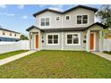 Inviting two-story home showcasing a lush green lawn and neatly aligned walkways at 3457 17Th S Ave, St Petersburg, FL 33711