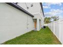 Exterior side view featuring a well-maintained lawn and neutral color palette at 3457 17Th S Ave, St Petersburg, FL 33711