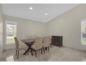 Elegant dining room with a modern table set, complemented by natural light streaming through the windows at 3506 Seaway Dr, New Port Richey, FL 34652