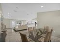 Open-concept living space flows into the dining and kitchen areas, perfect for entertaining with abundant light at 3506 Seaway Dr, New Port Richey, FL 34652