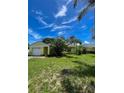 Bright single-story home with attached garage, well-maintained lawn, and inviting curb appeal on a sunny day at 3647 Lake St George Dr, Palm Harbor, FL 34684