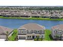 Aerial view of a luxury home overlooking beautiful water views, with neighboring homes nearby at 4423 Pond Brook Ct, Bradenton, FL 34211