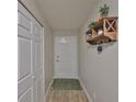 Bright entryway featuring a white door, wood-look floors, and a decorative shelf at 5108 26Th Street W Ct, Bradenton, FL 34207