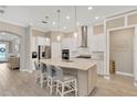Open kitchen with quartz countertops, stainless steel appliances, and a large island with seating at 5128 Dockyard Pl, Land O Lakes, FL 34638