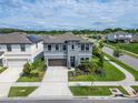 Gray two-story home with well-manicured landscaping and sidewalks at 5601 Limelight Dr, Apollo Beach, FL 33572