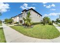 Beautiful two-story home with a well-manicured lawn and a sidewalk in front at 5601 Limelight Dr, Apollo Beach, FL 33572
