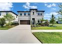 Beautiful gray two-story home with a well-manicured lawn and landscaping at 5601 Limelight Dr, Apollo Beach, FL 33572