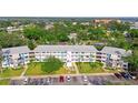 Overhead view of condos featuring mature trees, turquoise accents, and well-kept landscaping at 8533 110Th St # 207, Seminole, FL 33772
