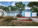 Beautiful front exterior of the home featuring a quaint white picket fence and beautiful plants at 9101 86Th Ave, Seminole, FL 33777