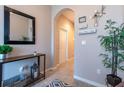 Inviting entryway with tiled floors, decorative mirror and console table with decor at 10425 Yellow Spice Ct, Riverview, FL 33578
