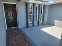 Covered entryway boasting unique architectural details and stylish black front door at 11715 Salmon Dr, Port Richey, FL 34668