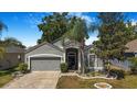 Attractive single-Gathering home with a well-kept lawn, mature landscaping, and a two-car garage enhancing curb appeal at 13215 Beechberry Dr, Riverview, FL 33579