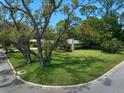 Mature trees canopy the well-manicured front lawn of this lovely single-Gathering home at 1431 Normandy Ln, Palm Harbor, FL 34683