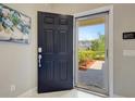 View through an open front door revealing the home's entrance and a glimpse of the exterior at 1949 Parterre Ave, Lutz, FL 33558