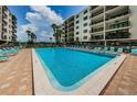 Inviting community pool with lounge chairs and a meticulously maintained deck, perfect for relaxation at 19531 Gulf Blvd # 604, Indian Shores, FL 33785