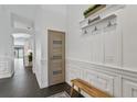 Inviting foyer featuring modern wainscoting, tile floors, and natural light at 24405 Summer Wind Ct, Lutz, FL 33559