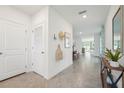 Long hallway with tile flooring offers ample space and access to various rooms, including the dining area at 32708 Winterwood Blvd, Wesley Chapel, FL 33543