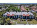 An aerial view of condos with red tile roofs, mature trees, and manicured lawns at 3281 Beneva Rd # 202, Sarasota, FL 34232